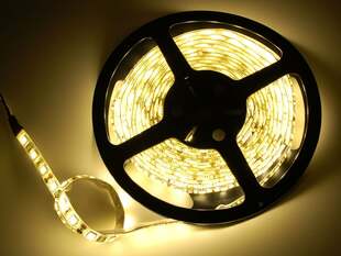 Powered on warm white LED strip on reel.